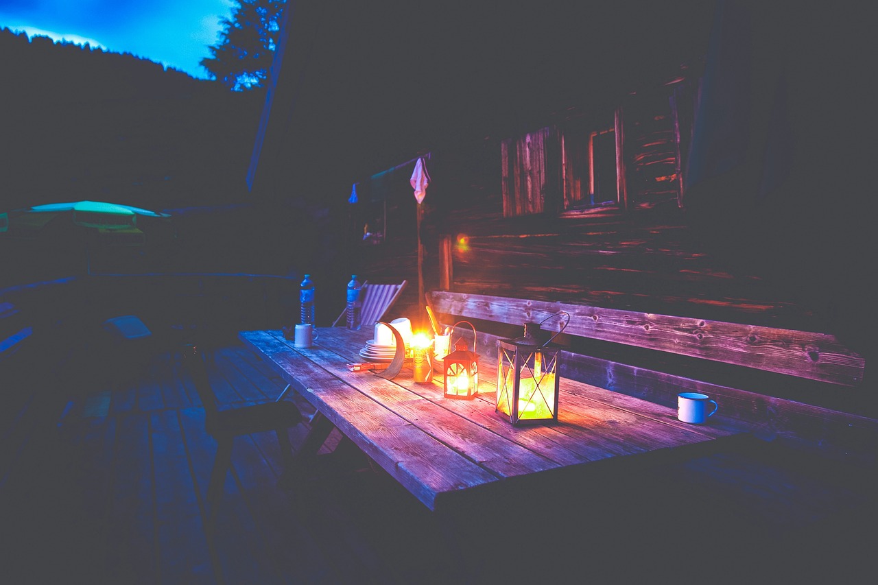 A backyard with string lights on after dark